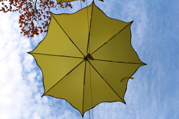 A yellow umbrella on a tree