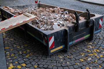 Shattered, broken red clay ceramic bricks, remnants of construction waste after building...