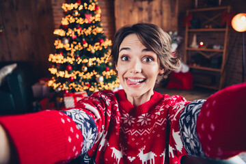 Selfie photo of funky young girl tongue stick out joking childish playing rejoice tradition atmosphere christmas vibe isolated indoors