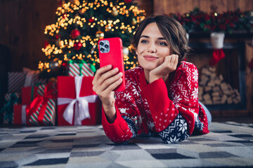 Full body photo of cute lady video call friends waiting santa claus hold iphone send wishlist shopping isolated xmas tree background