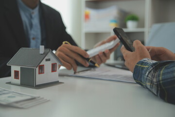 Real estate agent and customer signing contract to buy house, insurance or loan real estate.rent a house,get insurance or loan real estate or property.