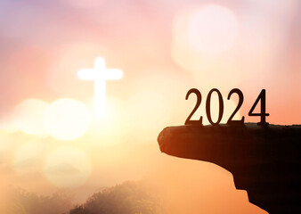 New hope concept: 2023 on sunset sky background with white cross