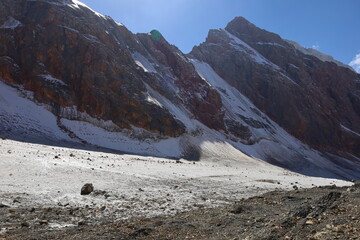 Rocky and glacial mountain landscape on a hiking trail from Iskandarkul to Chimtarga in Fann...