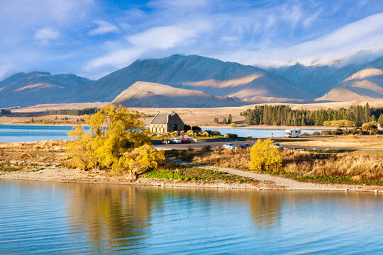 Church of the Good Shepherd on the shores of Lake Tekapo, Canterbury, New Zealand. Motorhome approaching the car park. This little church is on the tourist trail, and is an icon of New Zealand tourism