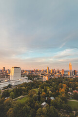 Naklejka na ściany i meble Sunset over Rotterdam city centre and its surrounding park. Sunset in one of the most modern cities in the Netherlands