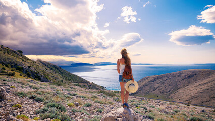 Woman tourist enjoying panoramic view of mountain and sea- Travel, vacation in Croatia