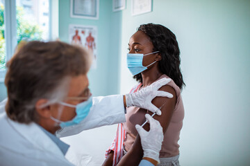 Young woman getting a flu shot at the hospital