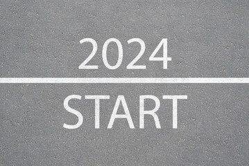 Text on the asphalt Start 2024 top view. New Year, beginning concept