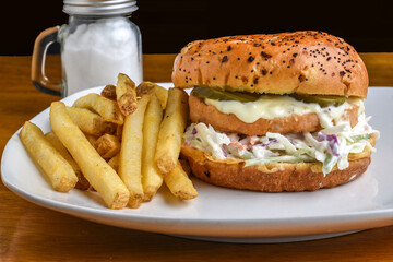 salmon burger with cole slaw on a everything  brioche bun