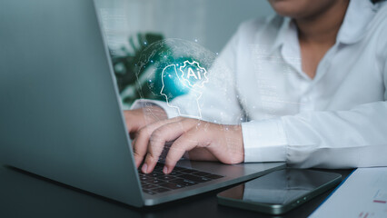 Businesswoman using computer and showing brain icon of AI represents the concept of learning of...