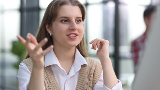 The girl looks thoughtfully at the laptop monitor. Online work. Distance learning. Freelancer works in a ofice.