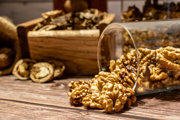 Peeled walnuts coming out of a jar on a table