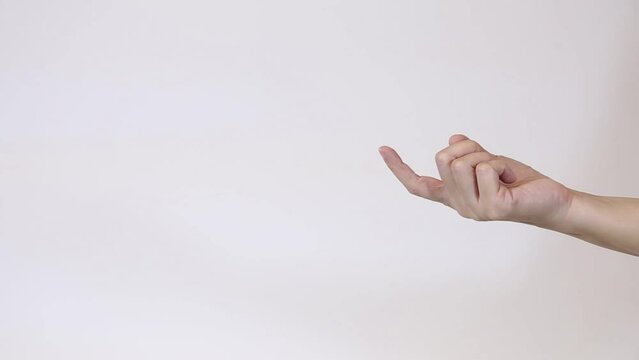 Unrecognizable woman giving beckoning finger sign. Close-up hand studio on white background. Flirt, temptation concept