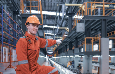 Young railway engineer  wearing  red safety uniform works in factory, railway transportation system
