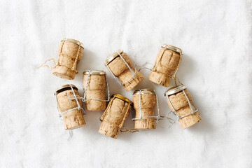 Creative minimal pattern of wine cork from sparkling wine on white fur, bottle stoppers top view wooden champagne corks with mushelets. Happy New Year concept, xmas, Christmas holidays photo.