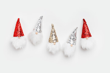 Christmas composition. Cute dwarfs with white beard and glittering sequins on cap white background....