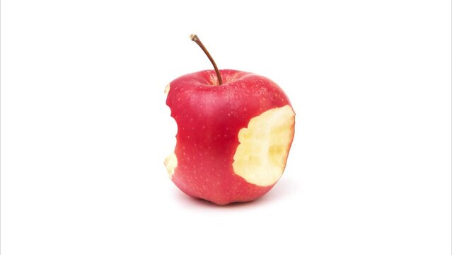 One red ripe apple becomes the core on a white background. Red apple from whole to core. Side view.