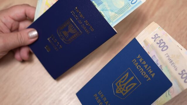 Passport of a citizen of Israel and passport of a citizen of Ukraine, repatriation, aliyah. Paper bills, new Israeli shekel and hryvnia. Absorption basket. Assistance under the Law of Return.
