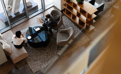 Top view of two business people talking in modern office, have conversation.