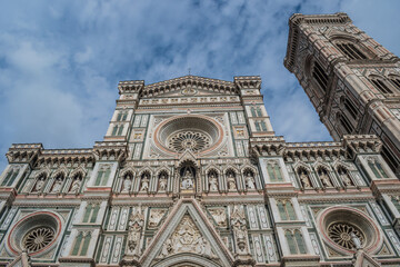 Detail of the facade of the Santa Maria del Fiore cathedral with Gothic rose windows and Giotto's bell tower, Florence ITALY