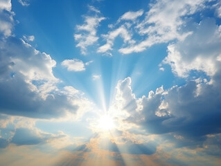 Sunbeam though cloudy above on blue sky background