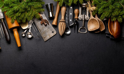 Kitchen utensils and fir tree branches on cooking table. Christmas cooking concept - obrazy, fototapety, plakaty