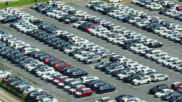 A birds-eye view unveils the potential of tomorrow's journeys. Rows of gleaming new cars, like promises of adventure, await their destined owners at the distribution center. Transport and car concept.