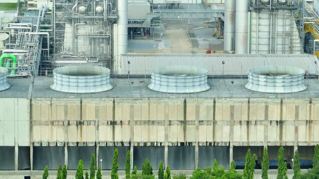 A drone's eye view reveals the sprawling power plant, its colossal turbines and towers standing like titans amidst an industrial landscape. Source of electric power worldwide.
