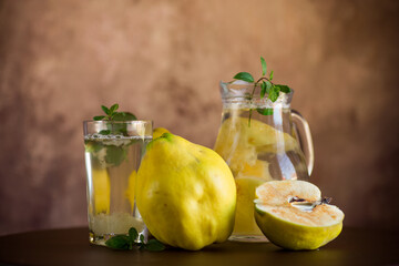Prepared compote from ripe natural autumn quince, in a glass glass and decanter .