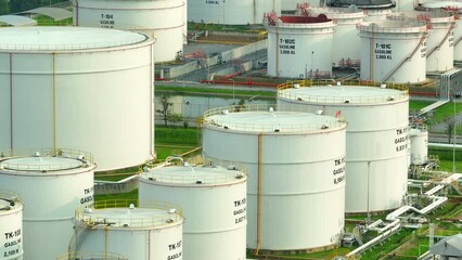 Drone captures oil depot's surreal juxtaposition in the cityscape, a modern oasis of fossil fuel reserves. The economic lifeblood of nations. Economic backbone: oil's global energy force.
 - Powered by Adobe