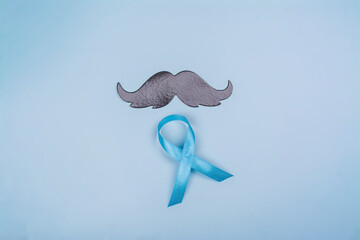 Black moustache and blue ribbon - symbol of men's health, suicide prevention. Mental health....