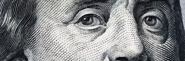 Benjamin Franklin's eyes from a hundred-dollar bill. The eyes of Benjamin Franklin on the hundred dollar banknote, backgrounds, close-up. 100 dollar bill with only eyes of Benjamin Franklin. - obrazy, fototapety, plakaty