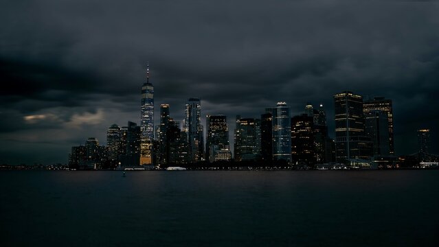 Photograph of the Financial District of New York City, stormy sky, buildings lit up in the early evening.