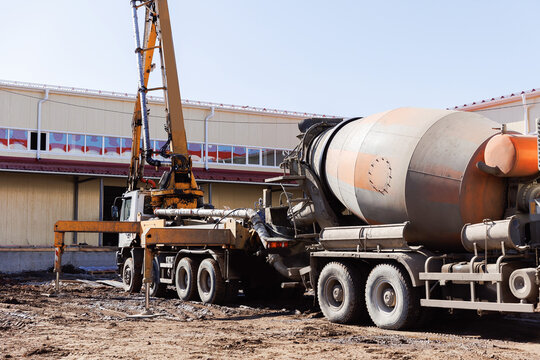 Mixer concrete move cement mortar to pump truck working on construction building site