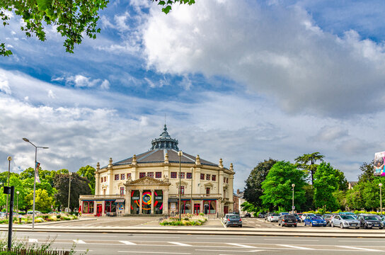 Amiens, France, July 3, 2023: The municipal circus Cirque Jules-Verne Pole National Cirque building between Square Arlette Gruss and Square Annie Fratellini, blue cloudy sky background, France