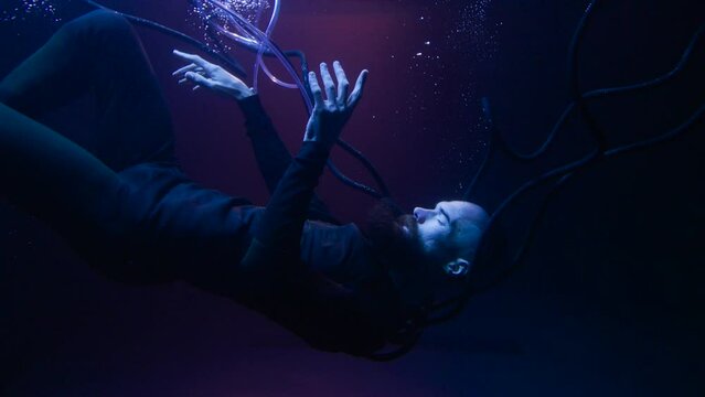 Man in futuristic costume under the water. Guy in glasses of virtual reality. Augmented reality game, future technology, AI concept. VR. 