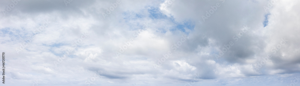 Wall mural panoramic grey sky with small blue sky patches