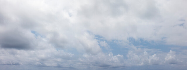 Panoramic grey sky with small blue sky patches