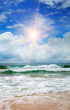 Beautiful seascape and sun on blue sky background. Vertical photo.