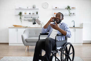 Close up view of african male with mobility impairment being involved in phone talk while relaxing...