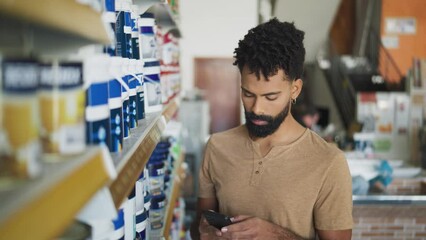 Searching at store and online. client with mobile phone looking at products and cell phone screen in hardware store