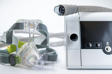 Continuous positive airway pressure system includes of CPAP machine, mask, tube on white background.