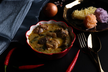 Chicken green curry with Rice Noodle Traditional northern local Thai food isolated in black background