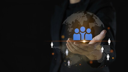 Hand holding touching glowing blue earth hologram on dark black background. Business and innovative technology concept.