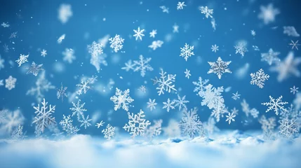 Fotobehang Background image of flying white snowflakes on a snowy blue background. © ArturSniezhyn