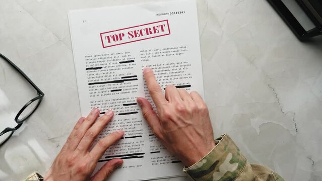 Soldier Reads Secret Documents. Top view
