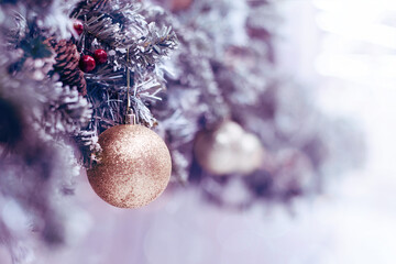 New Year's decor. Christmas background with decorative balls on a Christmas tree branch, soft selective focus, toned