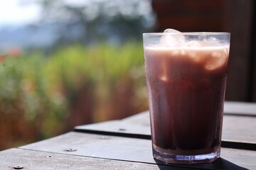 a glass of fresh drink on a wooden table