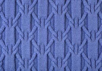 Fototapeta premium Knitted blue abstract background. Large knitted fabric with a pattern. Close-up of a knitted blanket. Copy space