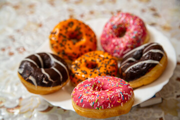Donuts with multi-colored glaze on a plate for Hanukkah